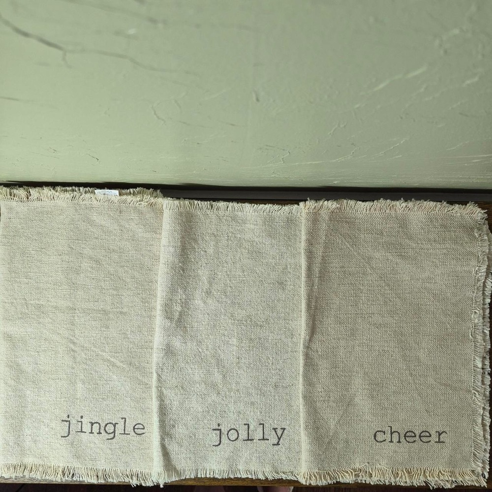 Cream Holiday Placemats (three total) - with the words 'jingle, jolly, & cheer'
